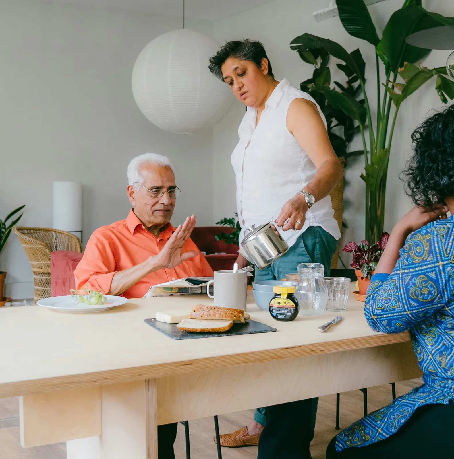 Caregiver and older adult sharing a meal