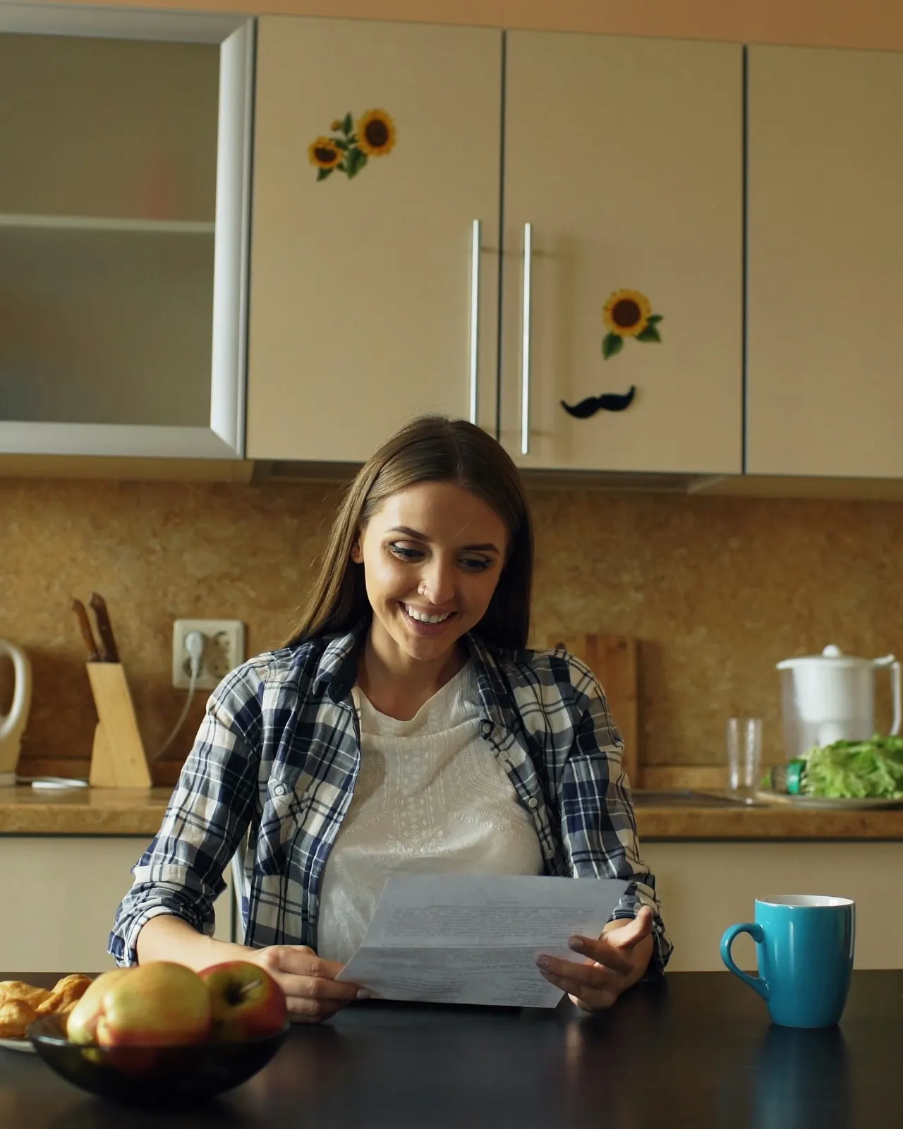 Family member reviewing paperwork at the kitchen table